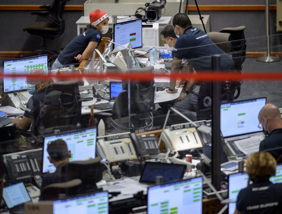 Launch teams monitor the countdown to the launch of Arianespace's Ariane 5 rocket carrying NASA's James Webb Space Telescope, Saturday, Dec. 25, 2021, in the Jupiter Center at the Guiana Space Center in Kourou, French Guiana. The world's largest and most powerful space telescope has blasted off on a high-stakes quest to behold light from the first stars and galaxies. NASA's James Webb Space Telescope rocketed away Saturday from French Guiana in South America. (NASA/Bill Ingalls/NASA via AP)