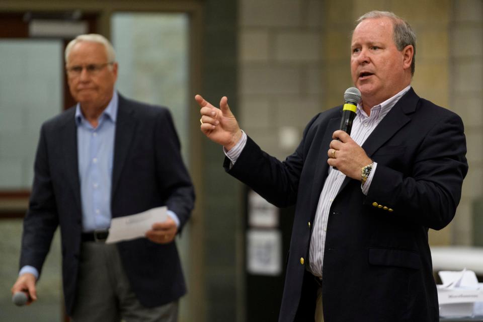 U.S. Rep. Larry Bucshon, right, answers a question as moderator David James of WNIN News, left, prepares to ask the next prepared question during a town hall meeting at the Southern Indiana Career & Technical Center in Evansville, Ind., Monday evening,  Aug. 19, 2019. 