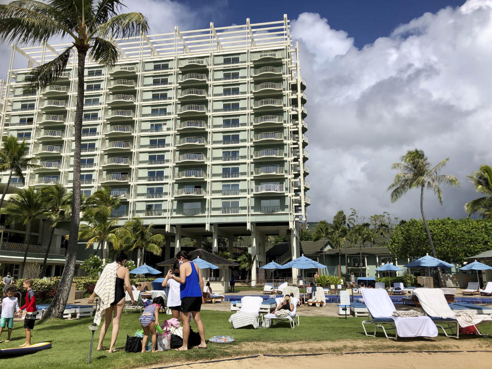 Guests are seen poolside at the Kahala Hotel & Resort in Honolulu, Sunday, Nov. 15, 2020. Some locals have mixed feelings about tourists returning during the pandemic after enjoying a Hawaii with dramatically fewer tourists since March. (AP Photo/Jennifer Sinco Kelleher)