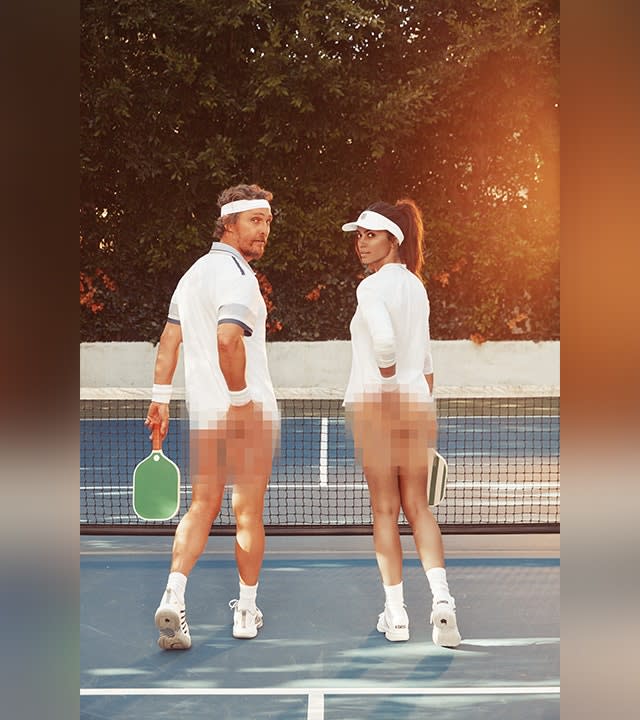 Matthew McConaughey and wife Camila in white tennis outfits look back at the camera on a pickleball court with their bums blurred and rackets