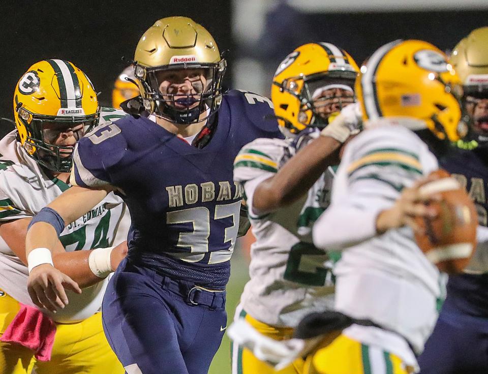 Hoban linebacker Eli Lee pressures St. Edward quarterback Thomas Csanyi on Friday in Akron.