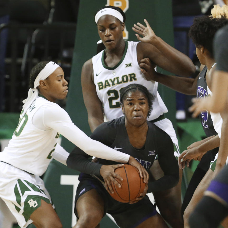 TCU forward Adeola Akomolafe, center, is pressured while passing the ball over Baylor guard Juicy Landrum, left, and center Kalani Brown in the second half of an NCAA college basketball game, Saturday, Feb. 9, 2019, in Waco, Texas. Baylor won 89-71. (AP Photo/Rod Aydelotte)