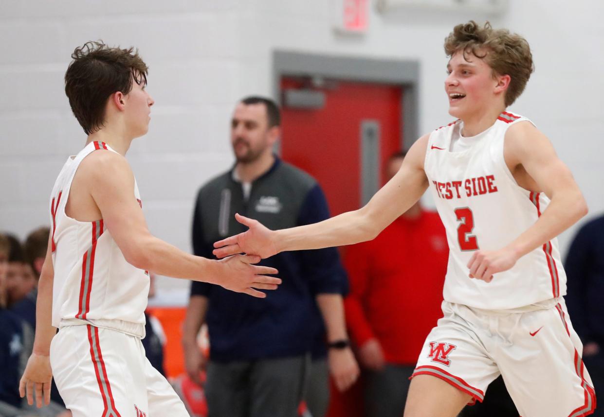 West Lafayette Red Devils Ben Werth (10) and West Lafayette Red Devils guard Drew Whitlock (2) high-five during the IHSAA boy’s basketball game against the Central Catholic Knights, Friday, Feb. 9, 2024, at West Lafayette High School in West Lafayette, Ind. West Lafayette Red Devils won 70-60.