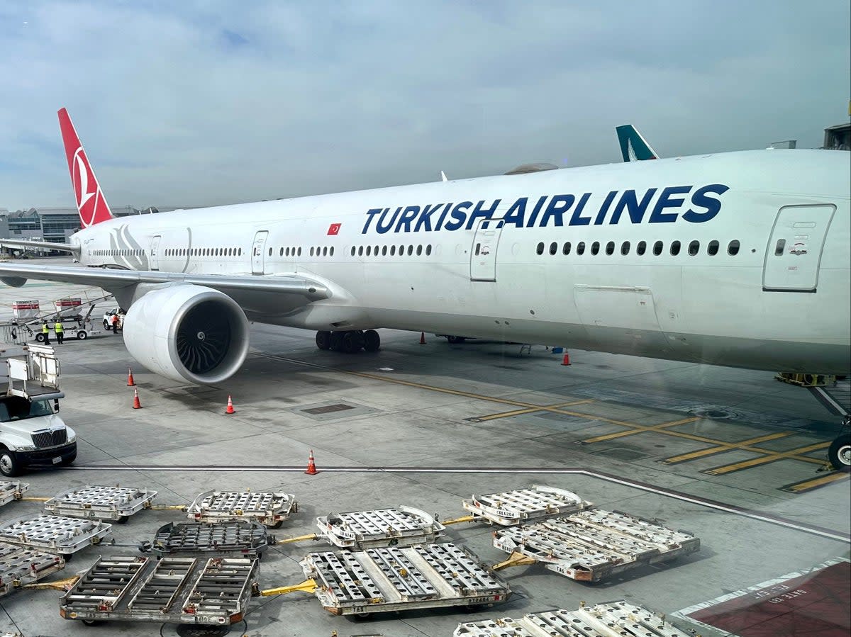 Empty baggage trucks are seen by a Turkish airlines Boeing 777 at Los Angeles International Airport (LAX) on January 11, 2023 (AFP via Getty Images)