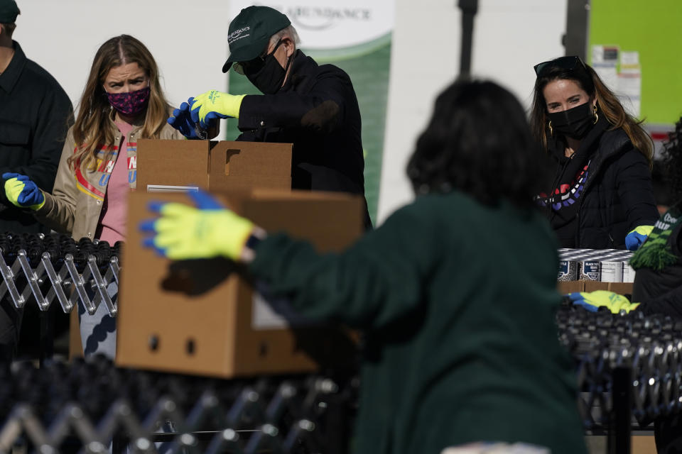 President-elect Joe Biden participates in a National Day of Service event at Philabundance, a hunger relief organization, with his daughter Ashley Biden, right, and his granddaughter Finnegan Biden, left, Monday, Jan. 18, 2021, in Philadelphia. (AP Photo/Evan Vucci)