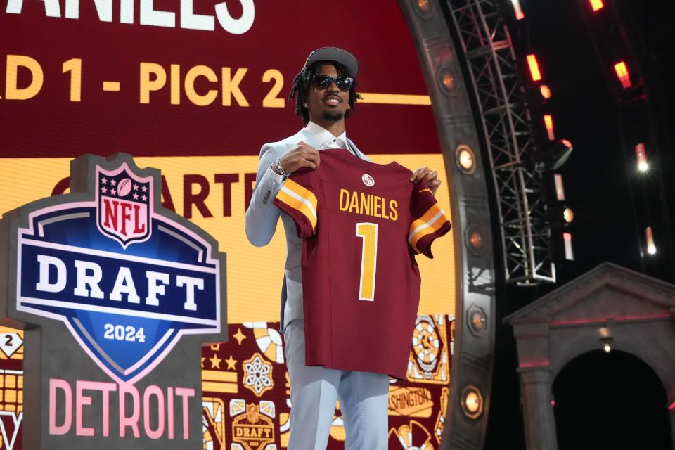LSU quarterback Jayden Daniels poses after being selected by the Washington Commanders as the No. 2 pick of the 2024 NFL draft.