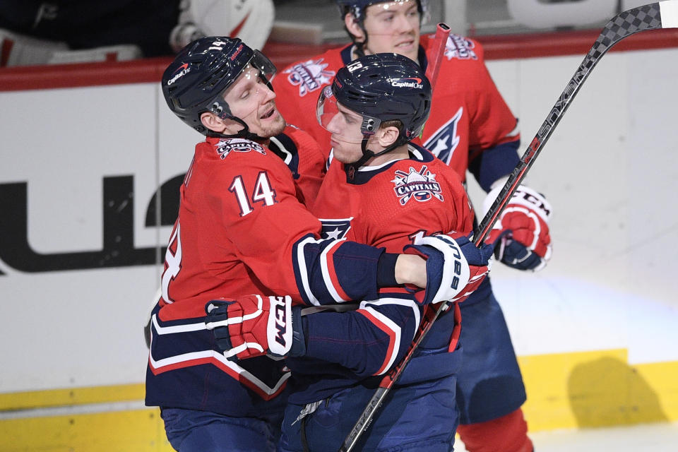 Washington Capitals left wing Jakub Vrana (13) celebrates his overtime goal with right wing Richard Panik (14) in the team's NHL hockey game against the New Jersey Devils, Tuesday, March 9, 2021, in Washington. The Capitals won 5-4. (AP Photo/Nick Wass)