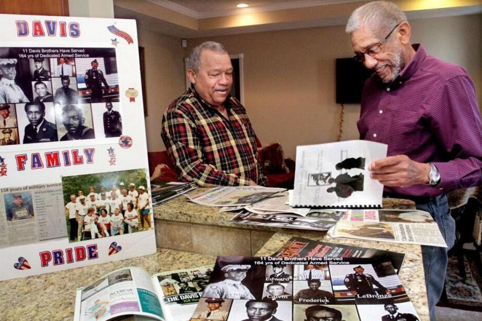Vietnam veteran Lebronze Davis, of Phenix City, Ala., left, and his brother Nathaniel Davis, of Montgomery, Ala., look through memorabilia and articles about the 11 Davis brothers from Wetumpka, Ala., who served a total of 158 years in the U.S. Armed Forces. The Davis’ and nine brothers served in the U.S. Army, the U.S. Navy and the U.S. Air Force. Two brothers and three daughters from the large farm family did not serve in the military.