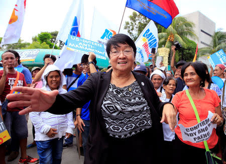 Judy Taguiwalo, a left-wing activist who was jailed during the 1970s martial law era of late dictator Ferdinand Marcos, demonstrates with her supporters, after Philippine lawmakers rejected the appointment of her as social welfare minister, during a Commission on Appointment hearing at the Senate headquarters, in Pasay City, Metro Manila, Philippines August 16, 2017. REUTERS/Romeo Ranoco