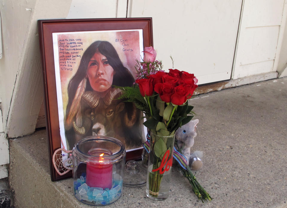 FILE - In a Monday, Aug. 28, 2017 file photo, a makeshift memorial to Savanna Greywind featuring a painting, flowers, candle and a stuffed animal is seen on Monday, Aug. 28, 2017, in Fargo, N.D., outside the apartment where Greywind lived with her parents. Republican U.S. Sen. Lisa Murkowski from Alaska is taking up the cause for a bill aimed at helping law enforcement with cases of murdered and missing indigenous women. Former North Dakota Democratic Sen. Heidi Heitkamp introduced and helped pass Savanna's Act in the Senate before she lost election, but it was blocked in the House by a retiring Republican. (AP Photo/Dave Kolpack, File)