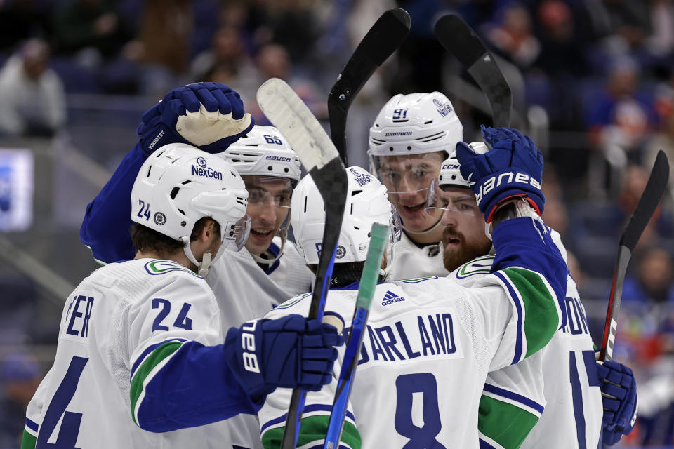 Vancouver Canucks defenseman Filip Hronek, right, is congratulated by teammates after scoring a goal against the New York Islanders during the first period of an NHL hockey game Tuesday, Jan. 9, 2024, in Elmont, N.Y. (AP Photo/Adam Hunger)