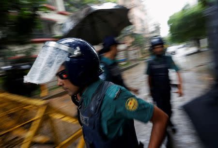 Policemen patrol on the road leading to the Holey Artisan Bakery and the O'Kitchen Restaurant after gunmen attacked, in Dhaka, Bangladesh, July 3, 2016. REUTERS/Adnan Abidi