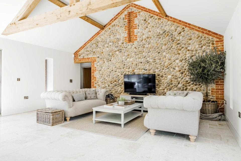 Eastern Daily Press: The living area has character and charm with a Norfolk flint wall