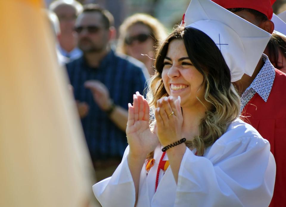 Bishop Connolly High Schooll student Cadence Olivia Camara applauds after the singing of the national anthem at her graduation ceremony, on Wednesday, May 31, 2023.