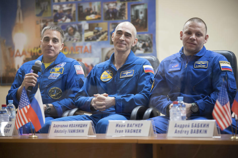 In this handout photo released by Roscosmos U.S. astronaut Chris Cassidy, left, Russian cosmonauts Anatoly Ivanishin, centre, and Ivan Vagner, members of the main crew to the International Space Station (ISS), attend a news conference at the Baikonur Cosmodrome, Kazakhstan, Wednesday, April 8, 2020. The new Soyuz mission to the International Space Station is scheduled on Thursday, April 9. (Roscosmos Space Agency Press Service via AP)