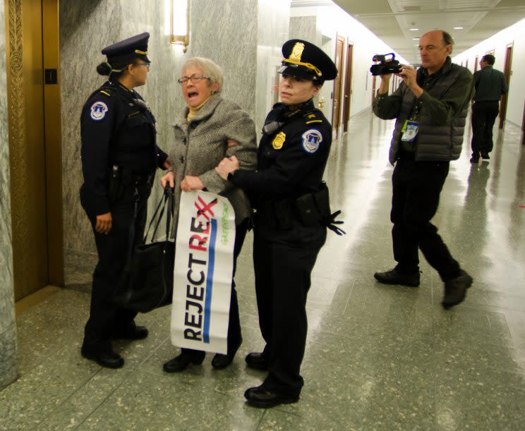 Activist Beth Henry of Charlotte, N.C., continues to protest as she is escorted from the confirmation hearing. (Photo: Pat Ryan/Greenpeace)