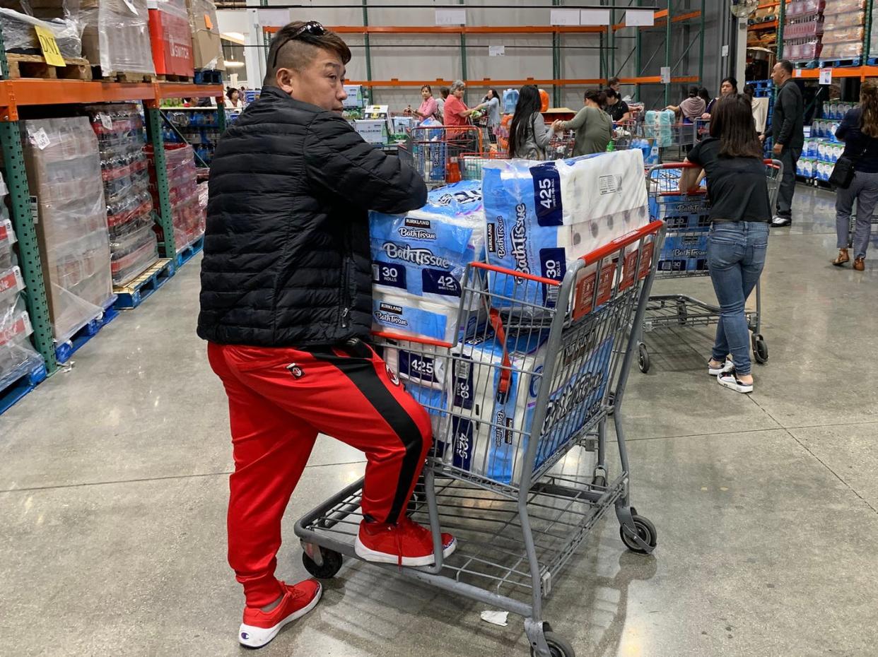 <span class="caption">As the number of COVID-19 cases jump, a Los Angeles man stocks up on toilet paper -- 150 rolls of it. </span> <span class="attribution"><a class="link " href="https://www.gettyimages.com/detail/news-photo/man-prepares-to-buy-150-rolls-of-toilet-paper-at-a-store-as-news-photo/1204234226?adppopup=true" rel="nofollow noopener" target="_blank" data-ylk="slk:Getty Images/Mark Ralston;elm:context_link;itc:0;sec:content-canvas">Getty Images/Mark Ralston</a></span>