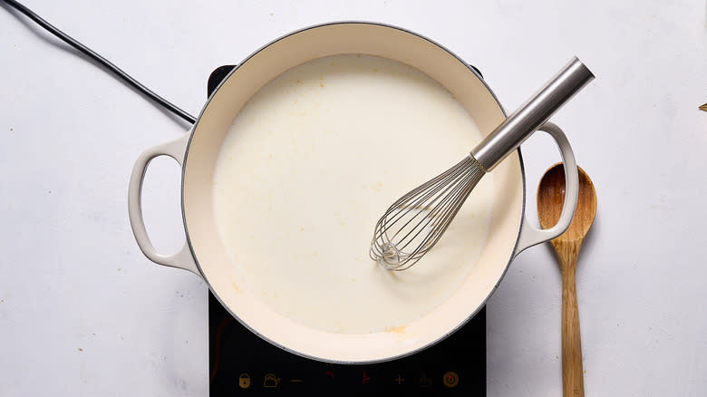 whisking milk into skillet