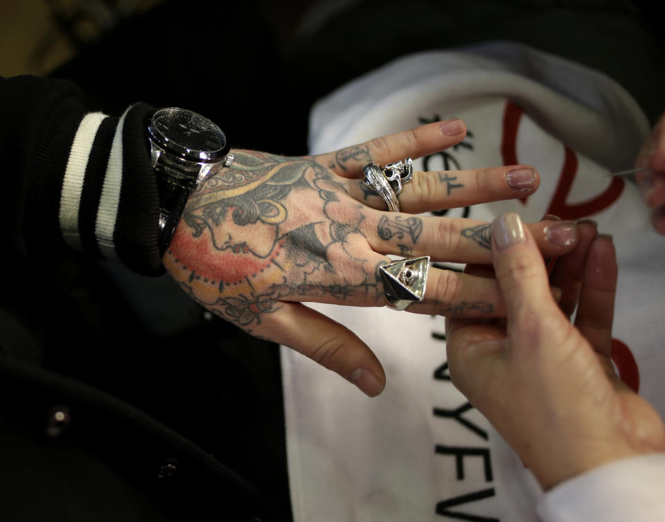 Jimmy Q. of London, England has his nails done backstage before the Fall 2014 DKNY collection is modeled during Fashion Week in New York, Sunday, Feb. 9, 2014. (AP Photo/Seth Wenig)