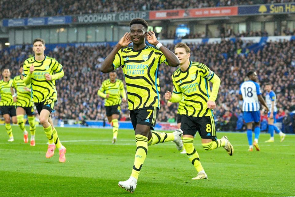 Bukayo Saka celebrates after scoring from the spot to put Arsenal ahead (AP)