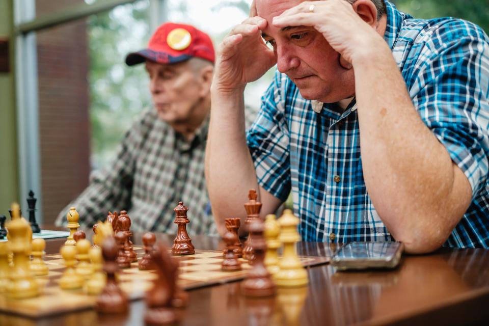 Bill Houghlan, right, of Dover, ponders over a chess game, Wednesday, Sept. 27 at the Dover Public Library.