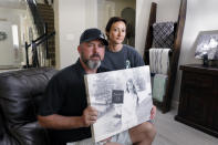 In this Oct. 12, 2021, photo, David and Wendy Mills, parents of Kailee Mills who was killed four years ago in an automobile accident when riding in the back seat without a seat belt, with a photo of their daughter at their home in Spring, Texas. The teenager was riding in the back seat of a car to a Halloween party in 2017 just a mile from her house when she unfastened her seat belt to slide next to her friend and take a selfie. Moments later, the driver veered off the road and the car flipped, ejecting her. (AP Photo/Michael Wyke)