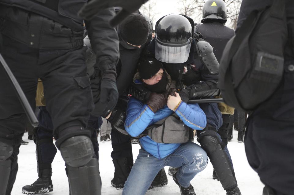 Police detain protesters during a protest against the jailing of opposition leader Alexei Navalny in St. Petersburg, Russia, Sunday, Jan. 31, 2021. Thousands of people have taken to the streets across Russia to demand the release of jailed opposition leader Alexei Navalny, keeping up the wave of nationwide protests that have rattled the Kremlin. Hundreds have been detained by police. (AP Photo/Valentin Egorshin)