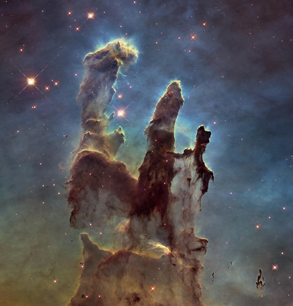 FILE - This file image made by the NASA/ESA Hubble Space Telescope shows the Eagle Nebula's "Pillars of Creation." Despite years of legal battles and months of protests by Native Hawaiian opponents, the international coalition that wants to build the world's largest telescope in Hawaii insists that the islands' highest peak, Mauna Kea, is the best place for their $1.4 billion instrument. Thirty Meter Telescope officials say their new instrument will produce images that are 12 times sharper than the Hubble Space Telescope. (NASA, ESA/Hubble, Hubble Heritage Team via AP)