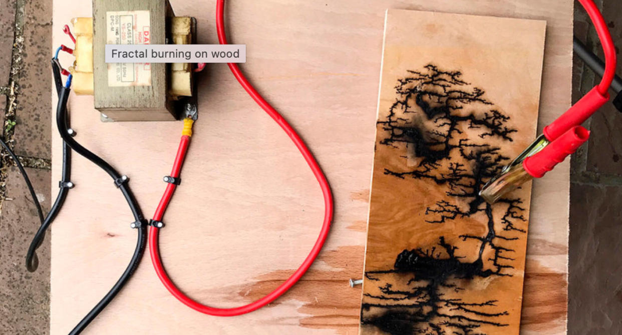 DIT woodburning device creating tree-like art on wood