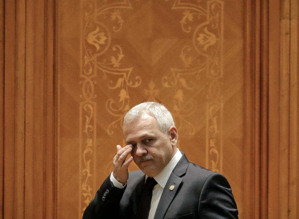 FILE - In this Thursday, Dec. 20, 2018 file photo, Head of the Ruling Social Democratic Party, Liviu Dragnea, wipes his eyes as he joins a parliament session during a no-confidence vote initiated by opposition parties in Bucharest, Romania. Dragnea who has clashed with the European Union over the government’s approach to fighting high-level corruption, is expected to miss events marking Romania’s six-month presidency of the bloc. (AP Photo/Vadim Ghirda, File)