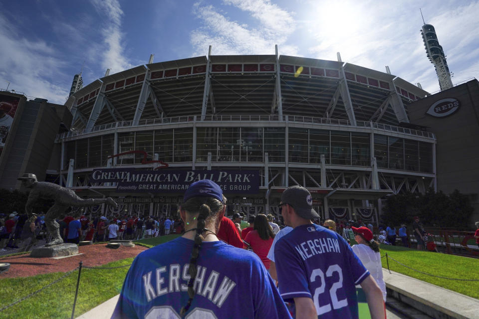 Los Angeles Dodgers' fans wait outside of Great American Ball Park prior to a baseball game between the Cincinnati Reds and the Los Angeles Dodgers in Cincinnati, Sunday, Sept 19, 2021. (AP Photo/Bryan Woolston)