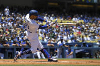 Los Angeles Dodgers' Mookie Betts hits a double during the first inning of a baseball game against the San Diego Padres Sunday, July 3, 2022, in Los Angeles. (AP Photo/Mark J. Terrill)