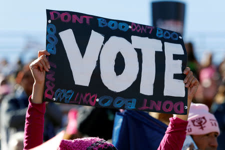 A woman holds a sign encouraging voters during the Women's March rally in Las Vegas, Nevada, U.S. January 21, 2018. REUTERS/Steve Marcus