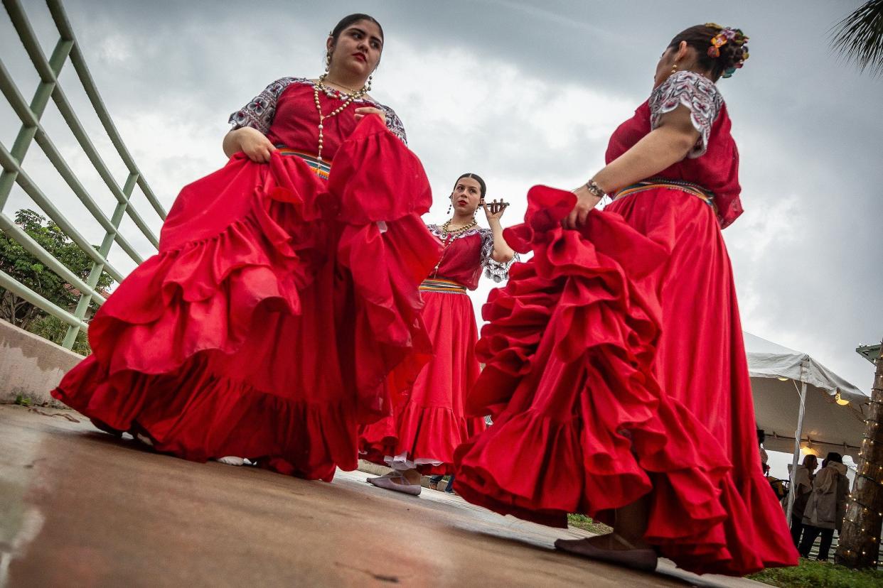 Left to right: Michelle Galeano and Mia Freitas, both of New York City, and Kiara Salazar of Orlando, rehearse their dance routine in Paraguayan dresses during the Fiesta de Pueblo-Three Kings Day celebration at Samuel J. Ferreri Community Park in Greenacres on Jan. 6.