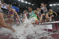 <p>Runners compete in the final of the women's 3,000-meters steeplechase at the 2020 Summer Olympics, Wednesday, Aug. 4, 2021, in Tokyo. (AP Photo/David J. Phillip)</p> 