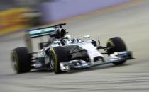 Mercedes Formula One driver Lewis Hamilton of Britain takes a corner on the Marina Bay street circuit during the first practice session of the Singapore F1 Grand Prix in Singapore September 19, 2014. REUTERS/Tim Chong