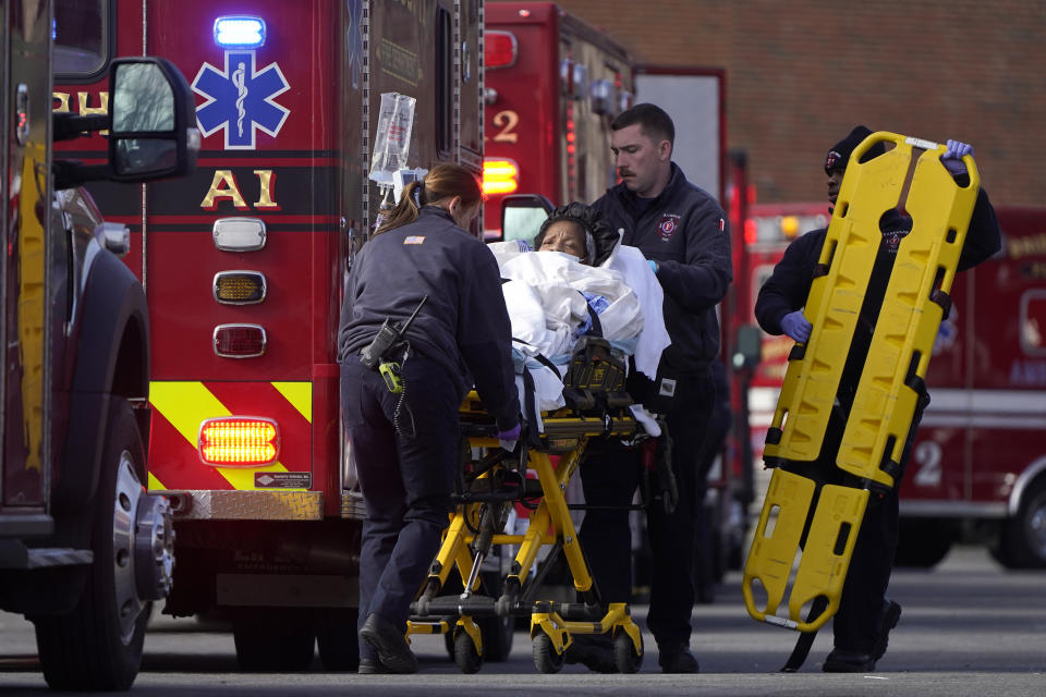 A patient, center, is placed into an ambulance while being evacuated from Signature Healthcare Brockton Hospital, Tuesday, Feb. 7, 2023, in Brockton, Mass. A fire at the hospital's electrical transformer forced an undetermined number of evacuations Tuesday morning and power was shut off to the building for safety reasons, officials said. (AP Photo/Steven Senne)