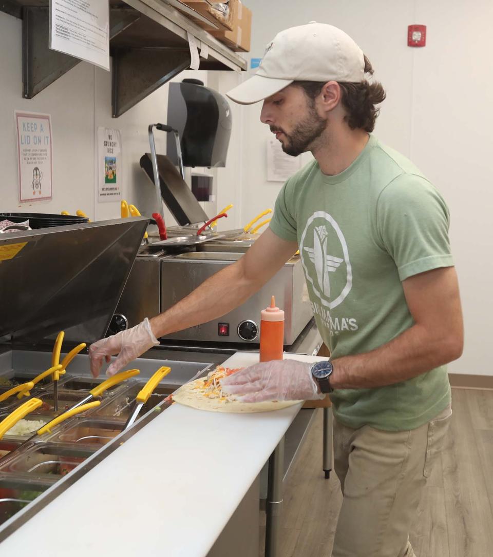 John D'Andrea makes a burrito at Big Mamma's Burritos, which has opened at the former site of Brubaker's Pub in downtown Akron.