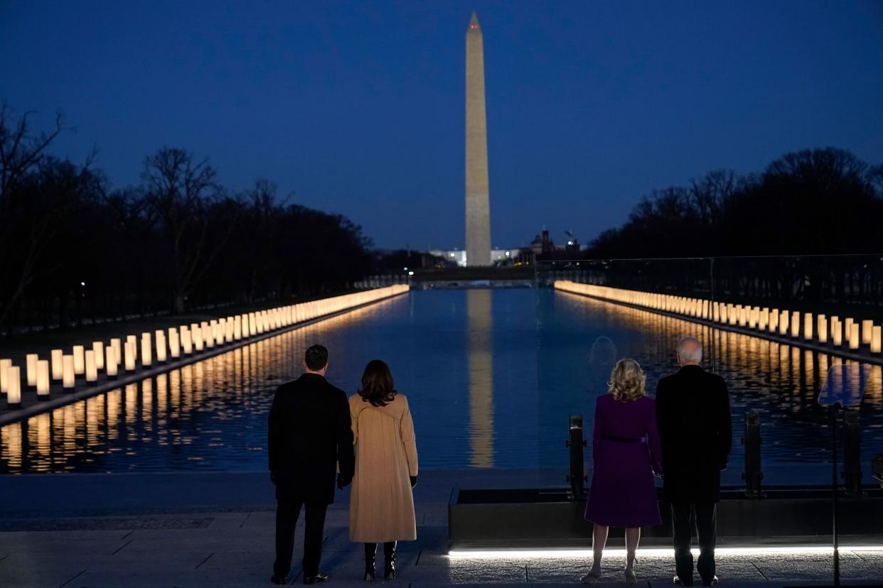 President-elect Joe Biden and his wife Jill Biden, along with Vice President-elect Kamala Harris and her husband, Doug Emhoff, look at lights placed around the Lincoln Memorial Reflecting Pool on Jan. 19, 2021, in Washington.  (AP Photo/Alex Brandon)