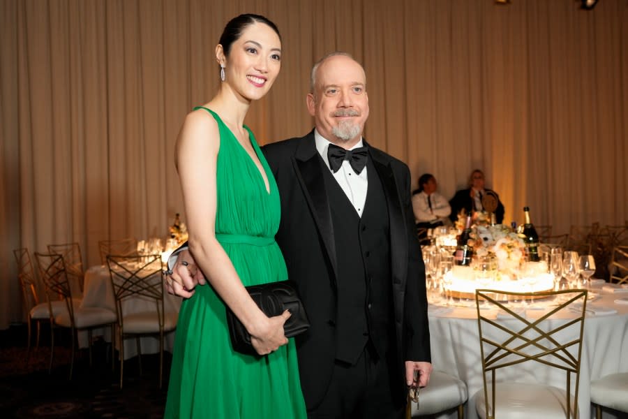 Clara Wong, left, and Paul Giamatti arrive at the 81st Golden Globe Awards on Sunday, Jan. 7, 2024, at the Beverly Hilton in Beverly Hills, Calif. (AP Photo/Chris Pizzello)