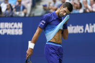 Novak Djokovic, of Serbia, wipes sweat from his face between serves from Daniil Medvedev, of Russia, during the men's singles final of the US Open tennis championships, Sunday, Sept. 12, 2021, in New York. (AP Photo/John Minchillo)