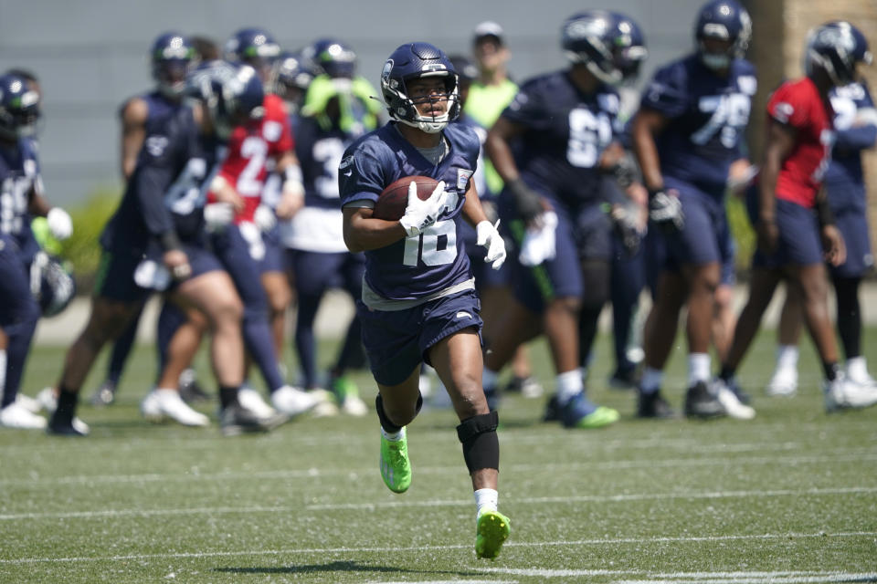 Seattle Seahawks wide receiver Tyler Lockett runs during NFL football practice, Tuesday, May 31, 2022, in Renton, Wash. (AP Photo/Ted S. Warren)