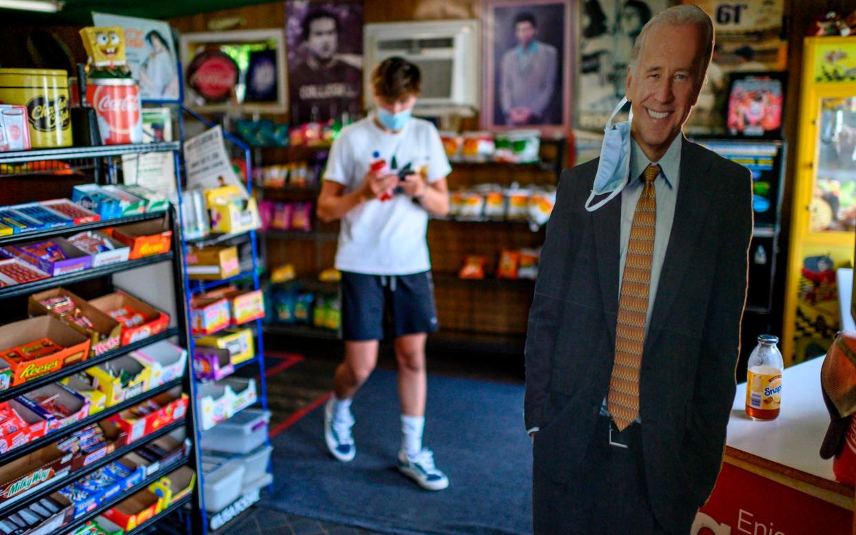 Customers walk past a cardboard effigy of Joe Biden at 'Hank's Hoagies' in Scranton - ERIC BARADAT /AFP
