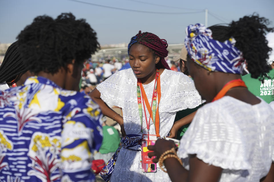 Pilgrims gather at Parque Tejo in Lisbon where Pope Francis is presiding over a mass celebrating the 37th World Youth Day, Sunday, Aug. 6, 2023. An estimated 1.5 million young people filled the parque on Saturday for Pope Francis' World Youth Day vigil, braving scorching heat to secure a spot for the evening prayer and to camp out overnight for his final farewell Mass on Sunday morning. (AP Photo/Ana Brigida)