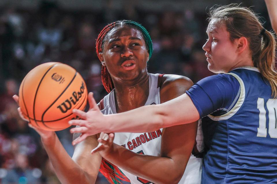 South Carolina forward Aliyah Boston, left, passes around Charleston Southern guard Kajsa Ahlberg during the first half of an NCAA college basketball game in Columbia, S.C., Sunday, Dec. 18, 2022. South Carolina won 87-23. (AP Photo/Nell Redmond)