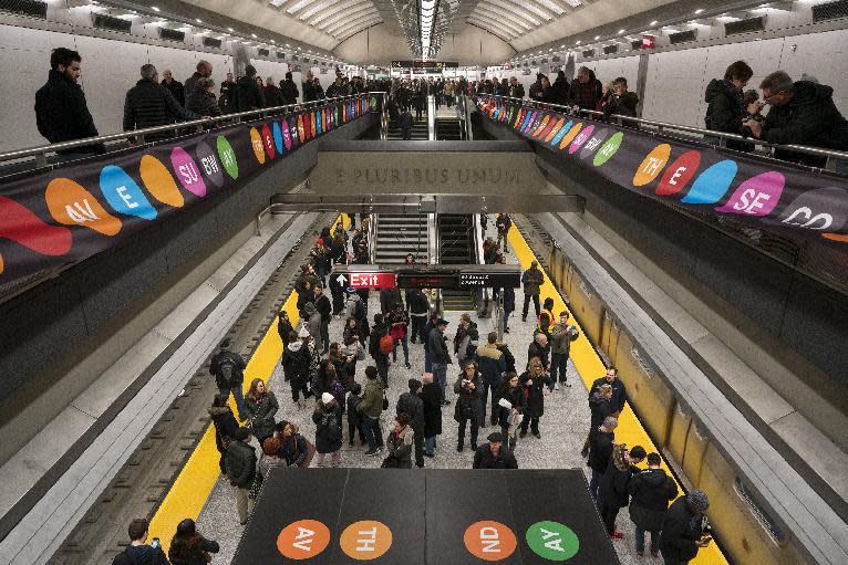 People walk about the newly opened Second Ave. Subway 86th Street station in New York Sunday, Jan. 1, 2017. The opening of three new stations on the newly opened Second Ave. subway marks a decades long plan to bring rail transportation to Manhattan's Upper East Side. (AP Photo/Craig Ruttle)