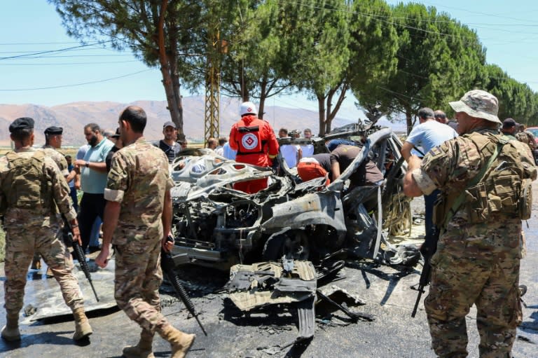 Security forces and emergency workers at the scene of the air strike (Hassan JARRAH)