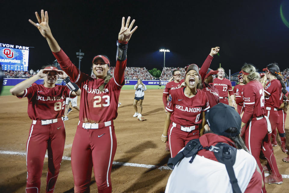 Oklahoma's Tiare Jennings (23), Rylie Boone (0) and Avery Hodge (82) celebrate the team's win over Texas in the NCAA Women's College World Series softball championship series Thursday, June 6, 2024, in Oklahoma City. (AP Photo/Alonzo Adams)