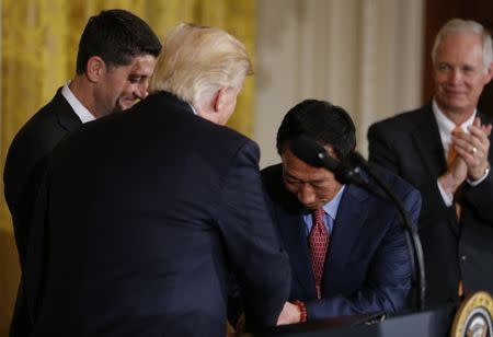 Foxconn Chairman Terry Gou (C-R) is greeted by U.S. President Donald Trump (2ndL) as House Speaker Paul Ryan (R-WI) (L) and Senator Ron Johnson (R-WI) applaud during a White House event where the Taiwanese electronics manufacturer announced plans to build a $10 billion dollar LCD display panel screen plant in Wisconsin, in Washington, U.S., July 26, 2017. REUTERS/Jonathan Ernst