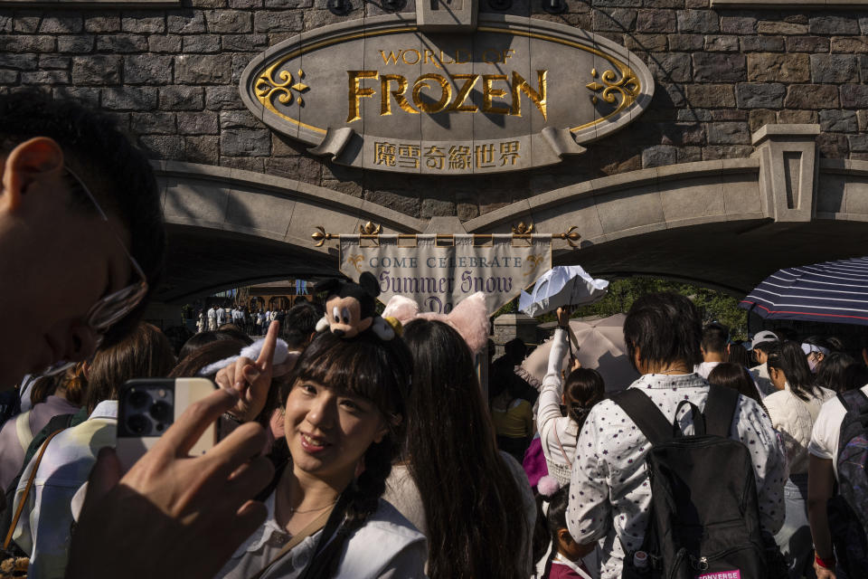 Visitors line up to enter the World of Frozen themed area during its opening ceremony at Disneyland Resort in Hong Kong, Monday, Nov. 20, 2023. (AP Photo/Louise Delmotte)